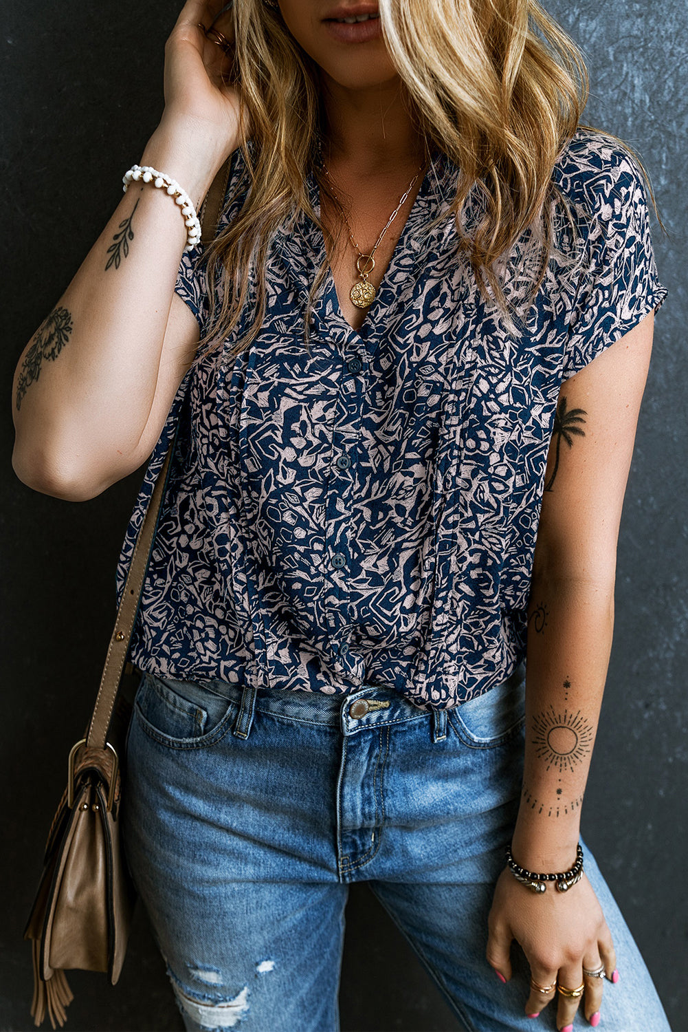 A stylish Buttoned V Neck Short Sleeve Blouse featuring a trendy pattern, short sleeves, and button details for a chic look.