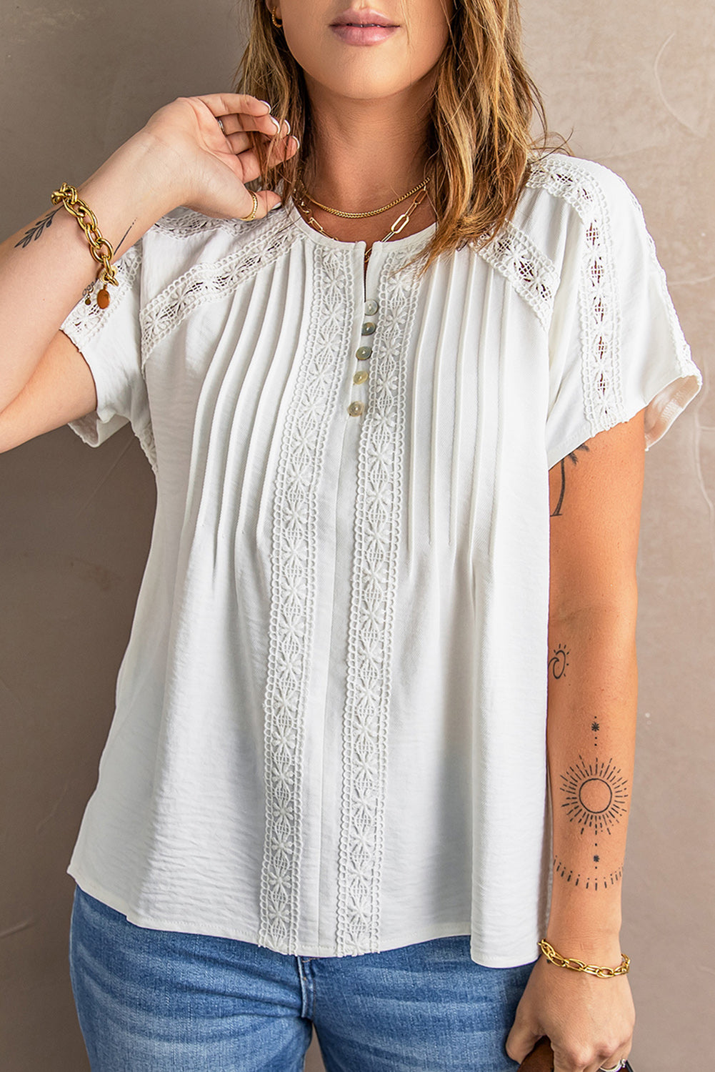 Chic white crochet eyelet blouse with short sleeves and v-neckline, featuring button decoration and hollow-out design, perfect for summer wear.