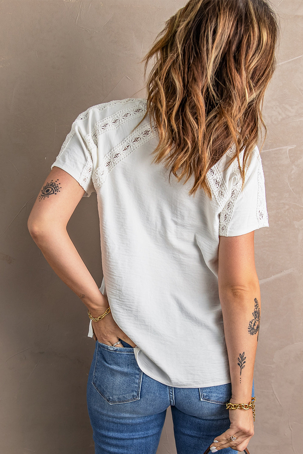 Chic white crochet eyelet blouse with short sleeves and v-neckline, featuring button decoration and hollow-out design, perfect for summer wear.