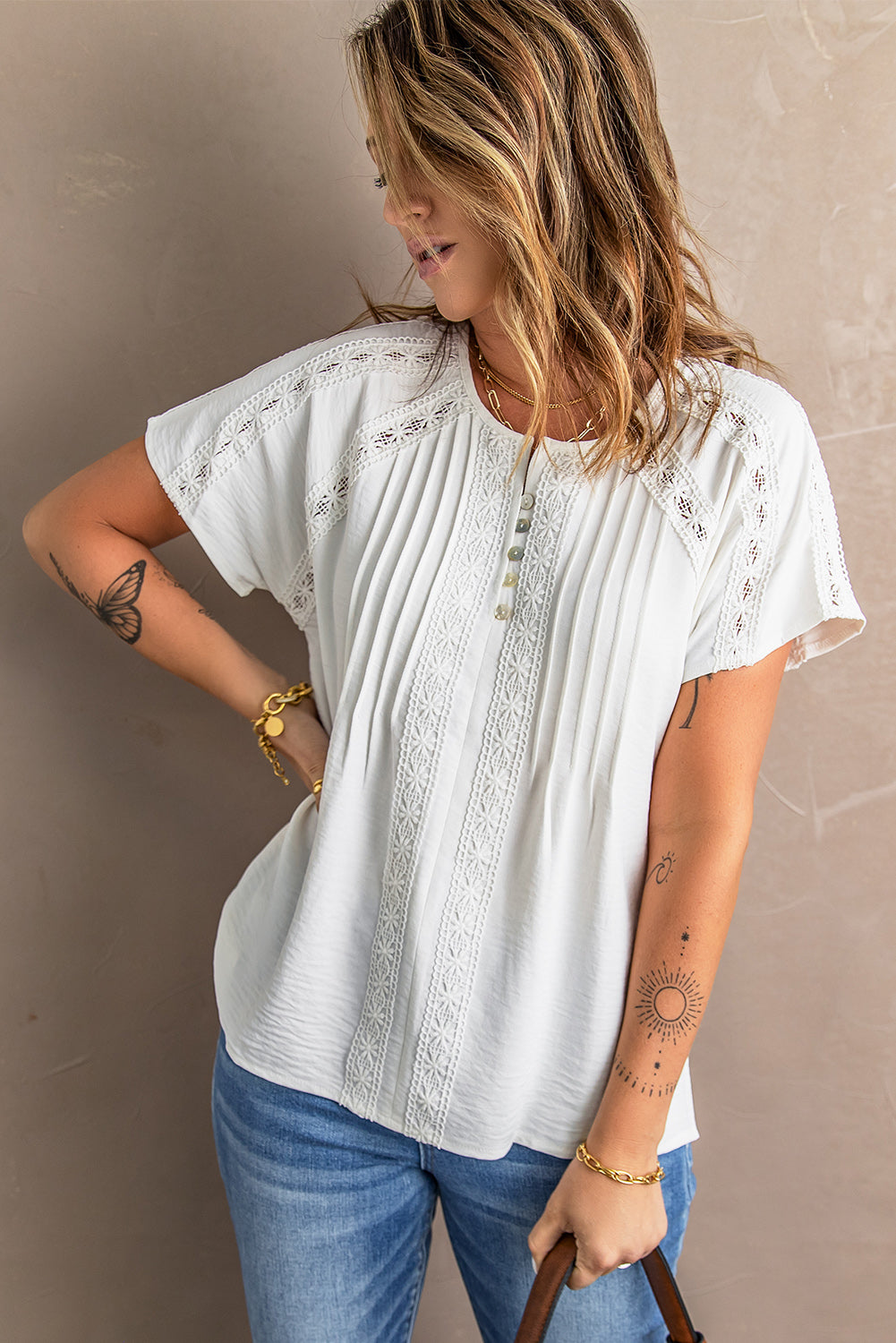 Chic white crochet eyelet blouse with short sleeves and v-neckline, featuring button decoration and hollow-out design, perfect for summer wear.