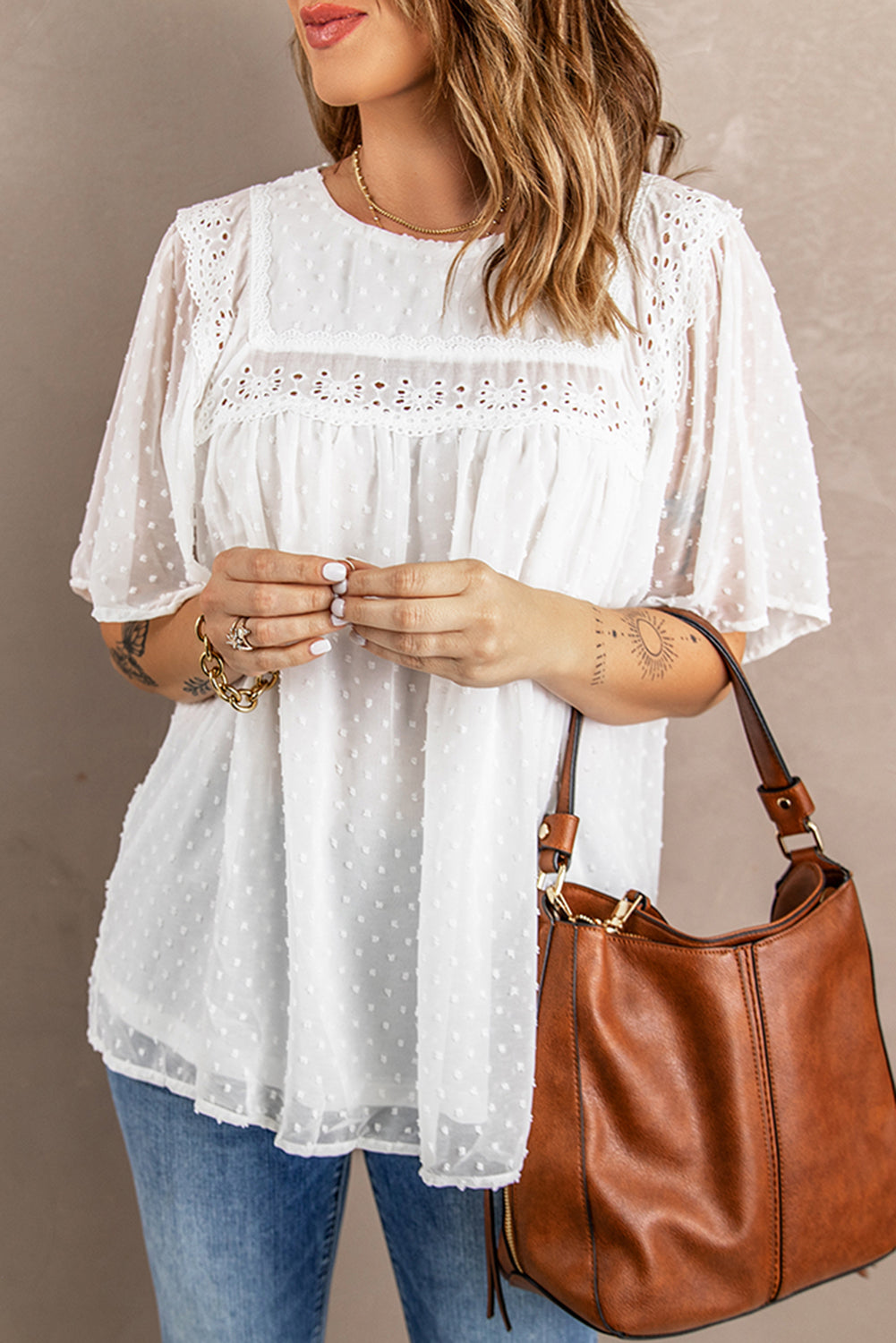 Chic white babydoll top with flutter sleeves and sheer textured design, perfect for summer wear.