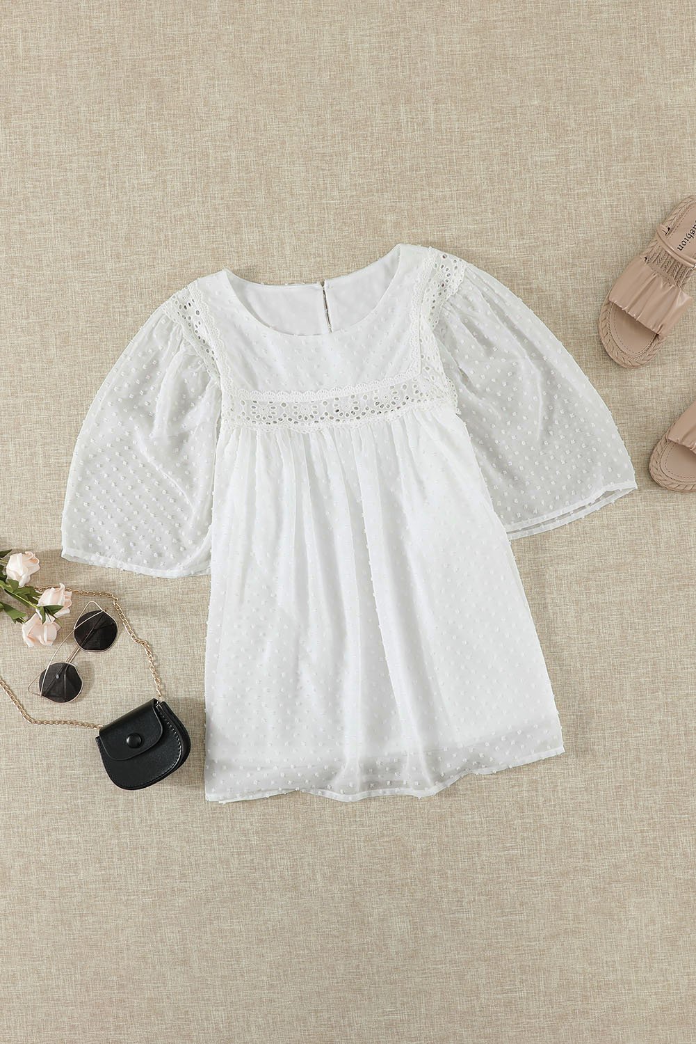 Chic white babydoll top with flutter sleeves and sheer textured design, perfect for summer wear.