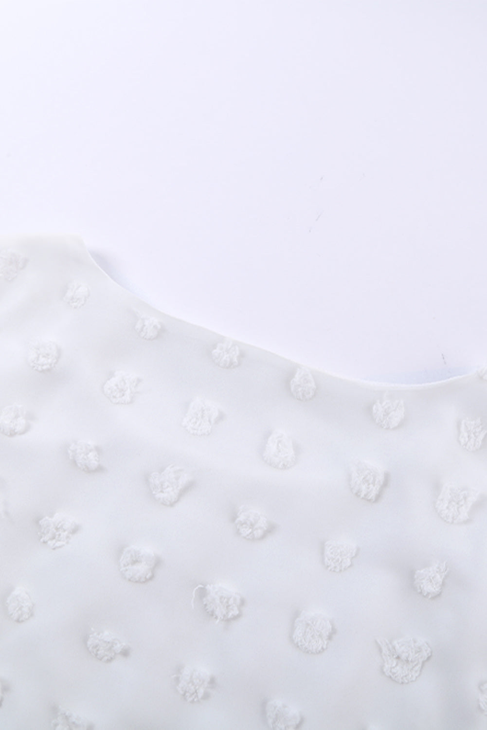 Chic White Swiss Dot Texture Round Neck Short Sleeve Top displayed on a mannequin, showcasing its elegant design and soft fabric.