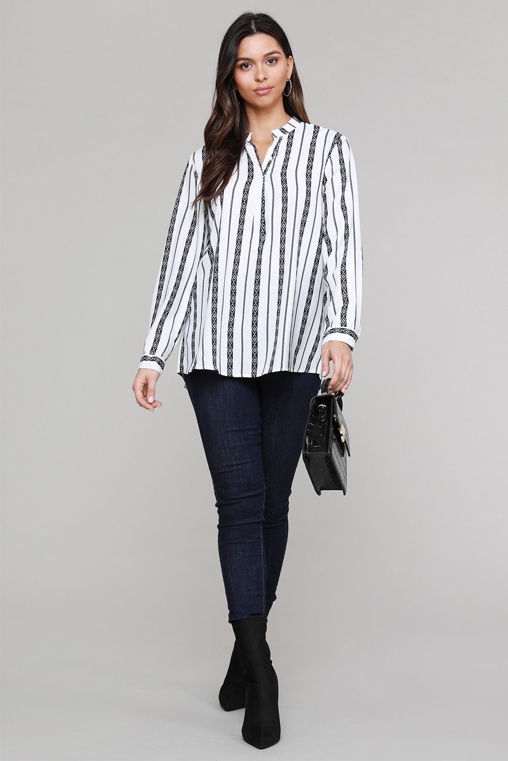 Classic black and white striped blouse with v-neck and button-up front, featuring long sleeves and a bohemian style.