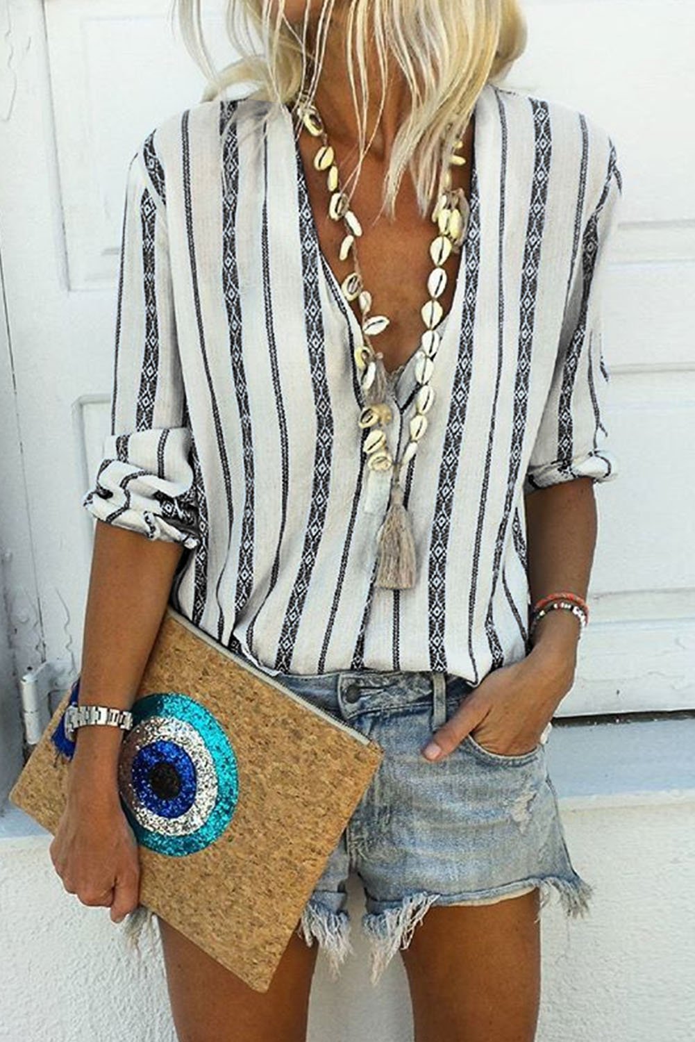 Classic black and white striped blouse with v-neck and button-up front, featuring long sleeves and a bohemian style.