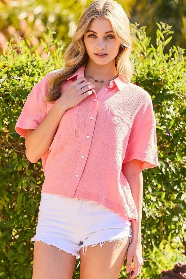 Coral collar neck button down top made of solid cotton gauze with front pockets.