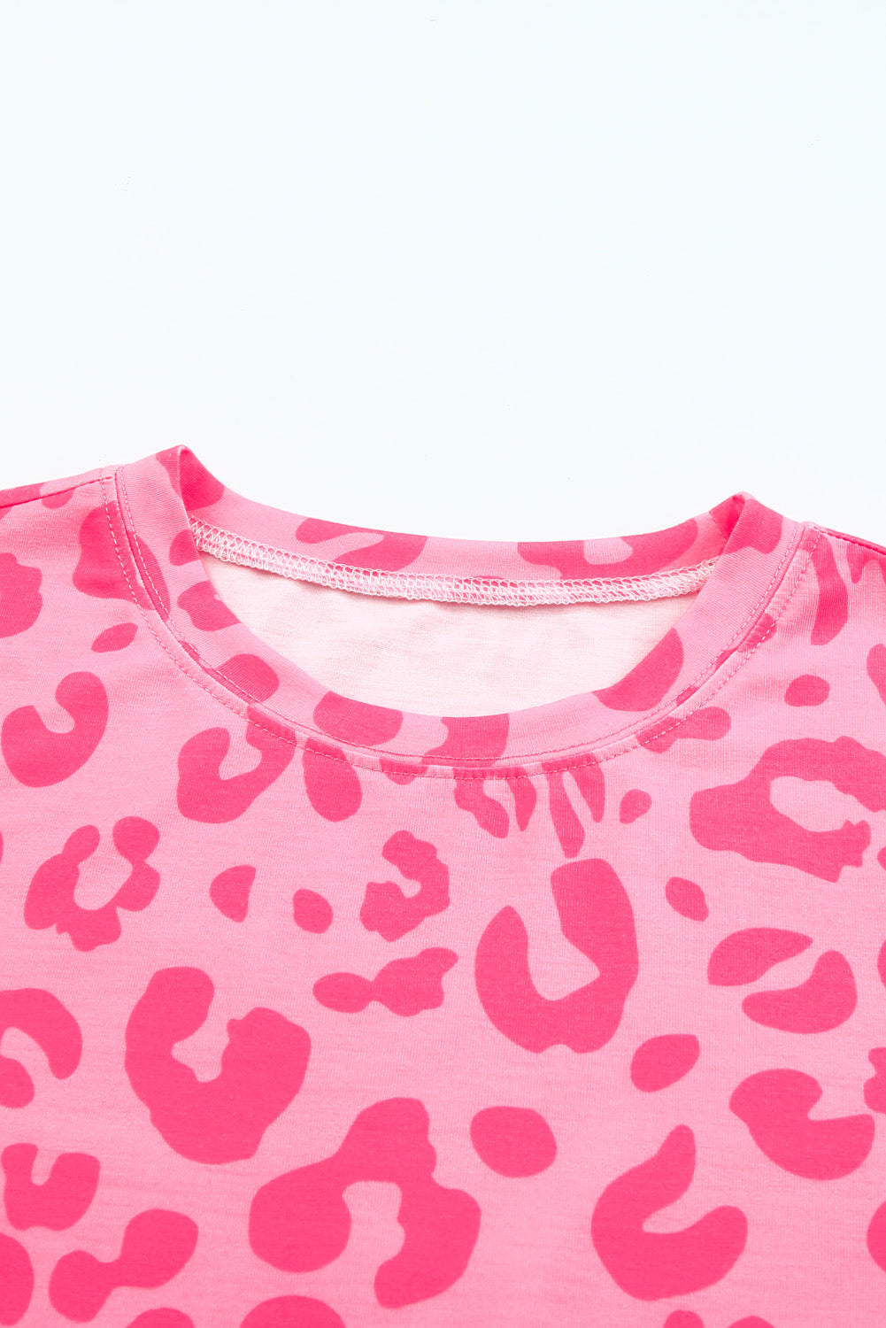 A stylish crew neck short sleeve t-shirt featuring a bold leopard print design, perfect for summer outfits.