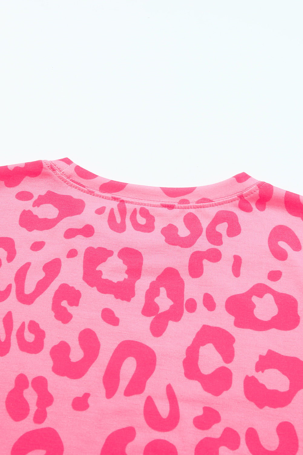 A stylish crew neck short sleeve t-shirt featuring a bold leopard print design, perfect for summer outfits.