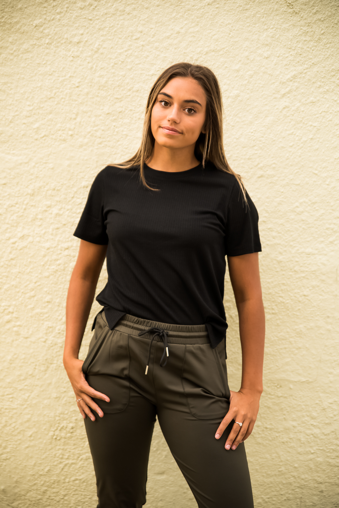 DT Alyssa Rib Knit Split Hem Tee in Black, showcasing its cozy ribbed fabric and stylish split hem design.