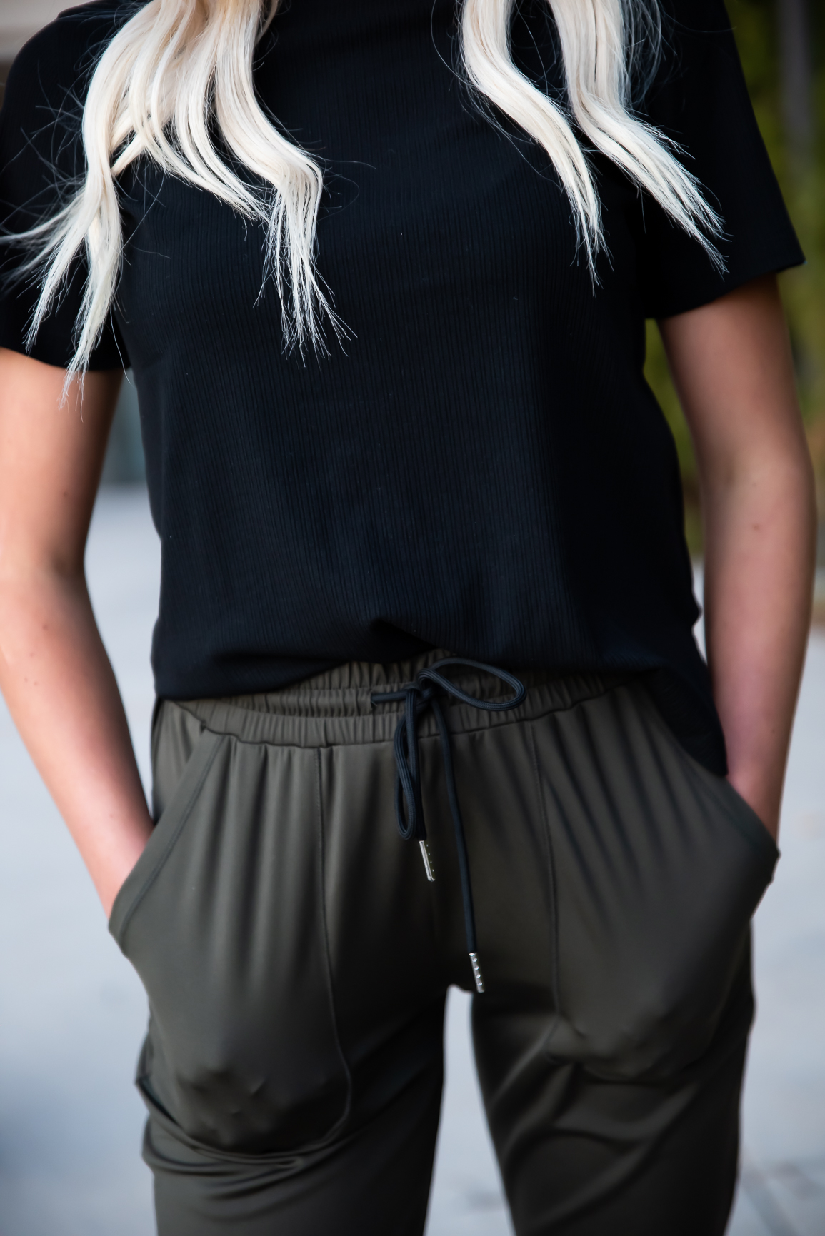 DT Alyssa Rib Knit Split Hem Tee in Black, showcasing its cozy ribbed fabric and stylish split hem design.