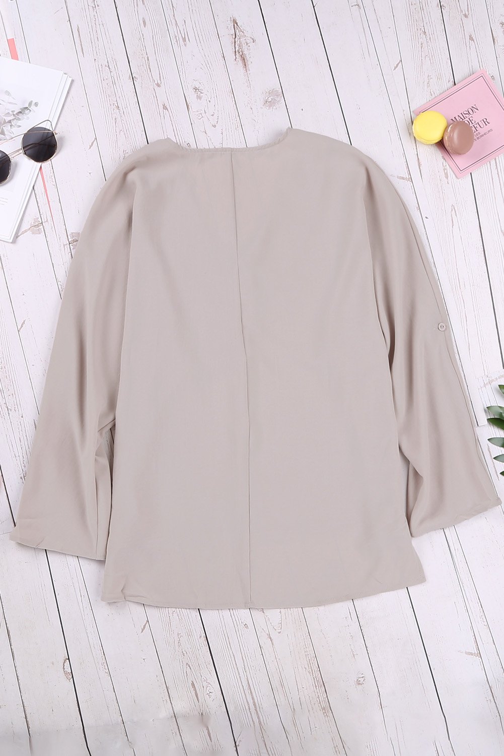 Elegant apricot v neck shirt with 3/4 sleeves and high low hem, showcasing a stylish and casual design.