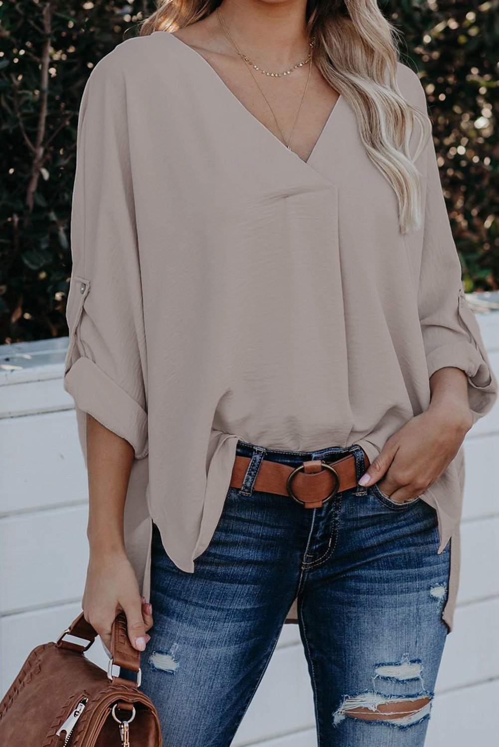 Elegant apricot v neck shirt with 3/4 sleeves and high low hem, showcasing a stylish and casual design.