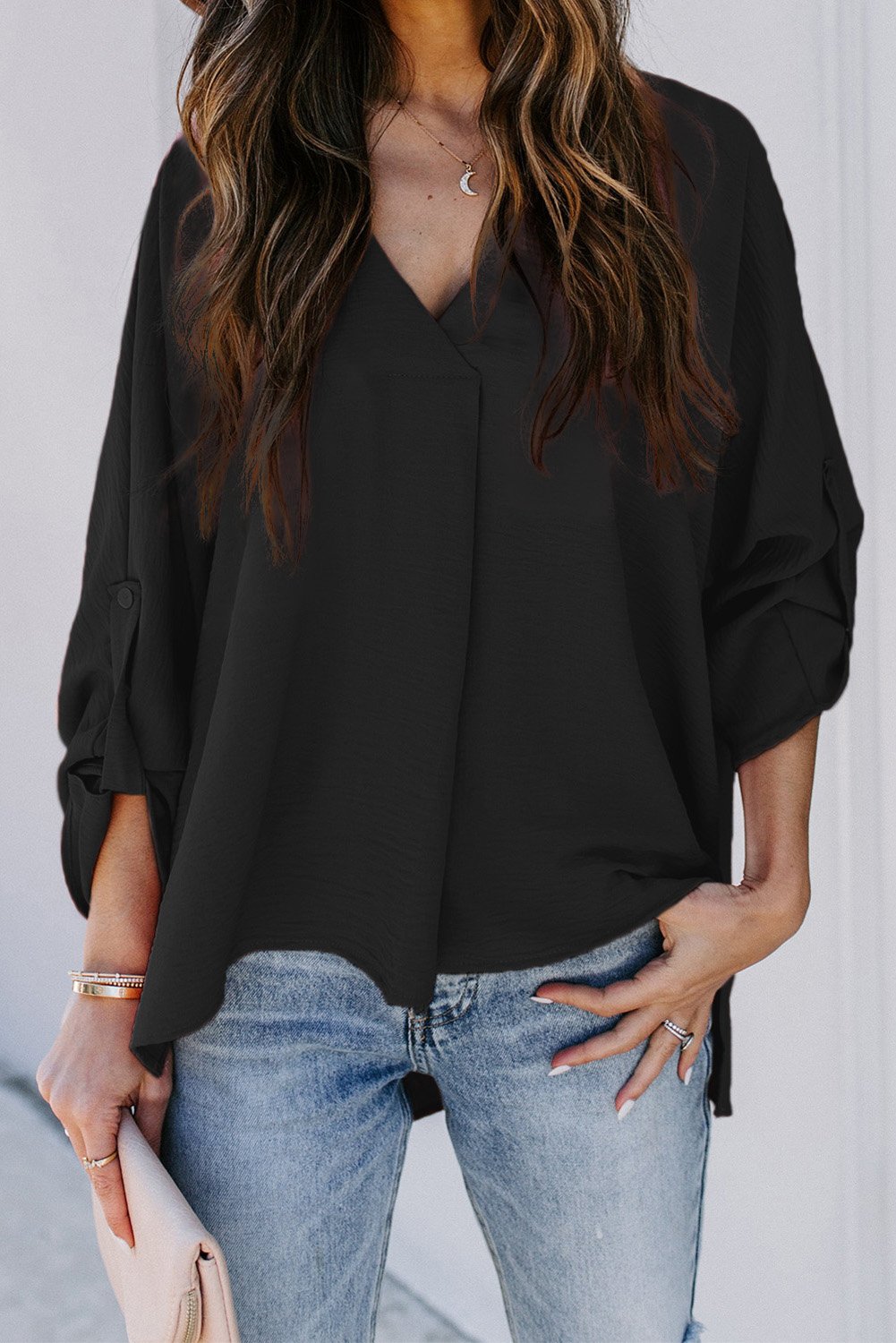 Elegant Black V Neck 3/4 Sleeve High Low Hem Shirt displayed on a mannequin, showcasing its stylish design and high low hemline.