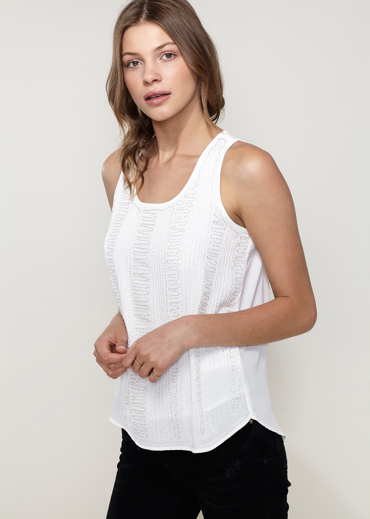 Embellished Accent Sleeveless Top in Ivory featuring elegant embellishments and a stylish round hem.