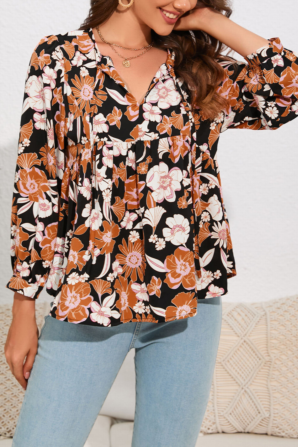 A stylish Floral Babydoll Blouse featuring a vibrant floral pattern, tie split neck, and bracelet sleeves, perfect for any occasion.