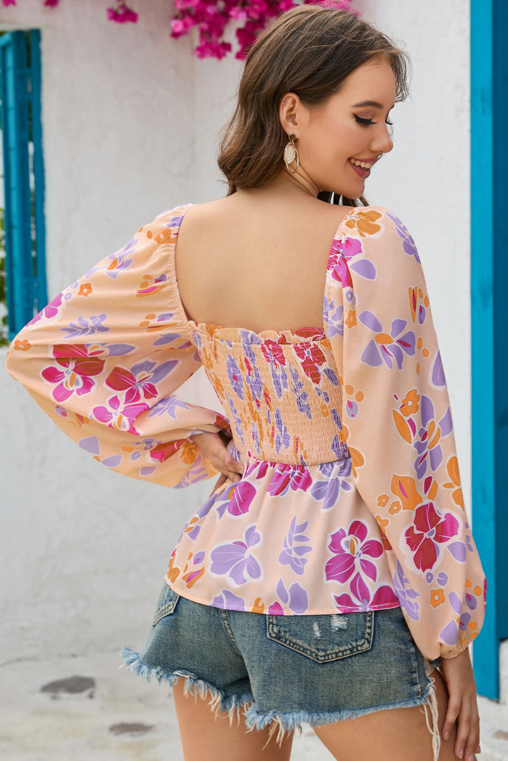 A stylish Floral Print Smocked Peplum Blouse featuring a frilled square neck, puff sleeves, and a vibrant floral pattern.