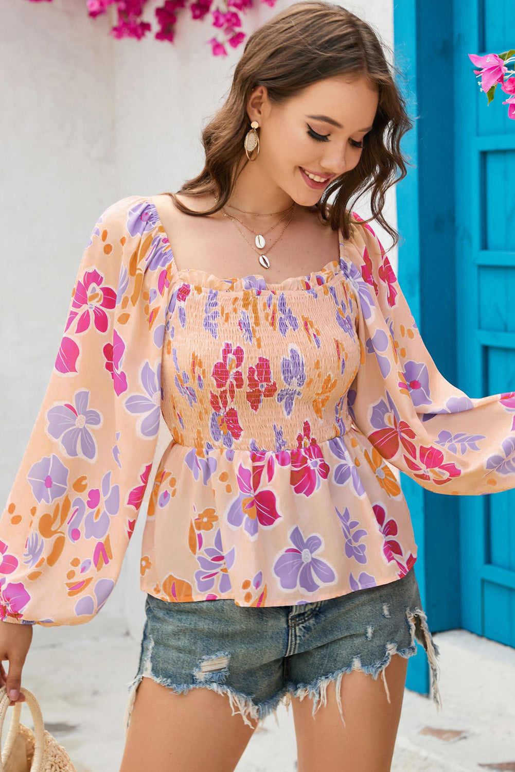 A stylish Floral Print Smocked Peplum Blouse featuring a frilled square neck, puff sleeves, and a vibrant floral pattern.