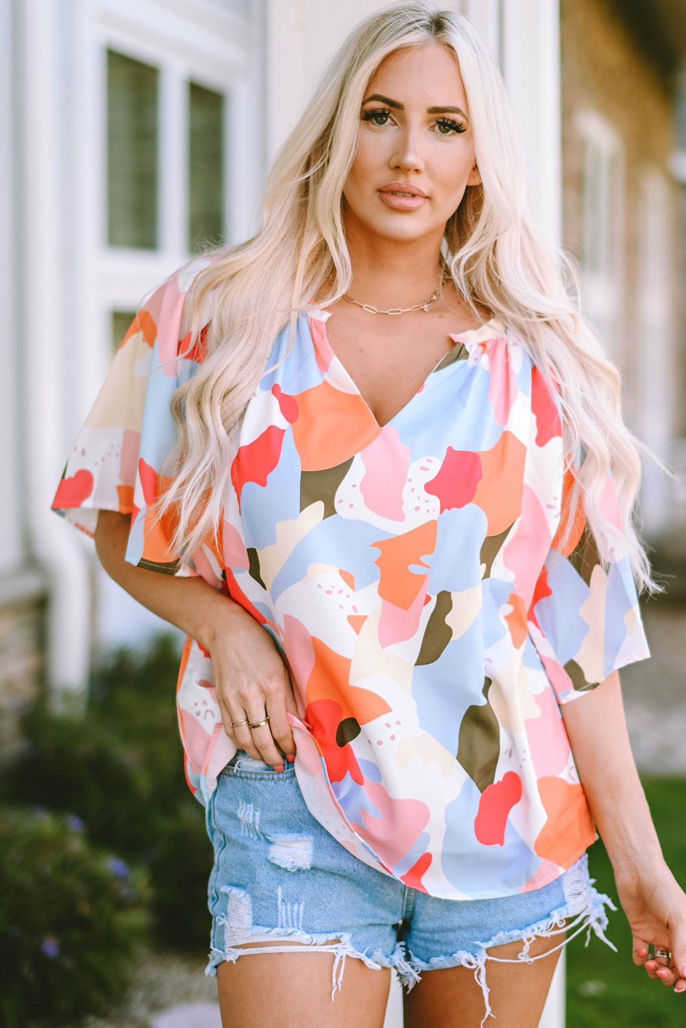 A stylish Floral Print V Neck Half Sleeve Blouse featuring a vibrant floral pattern, wide sleeves, and a flattering V-neckline, perfect for warm weather.