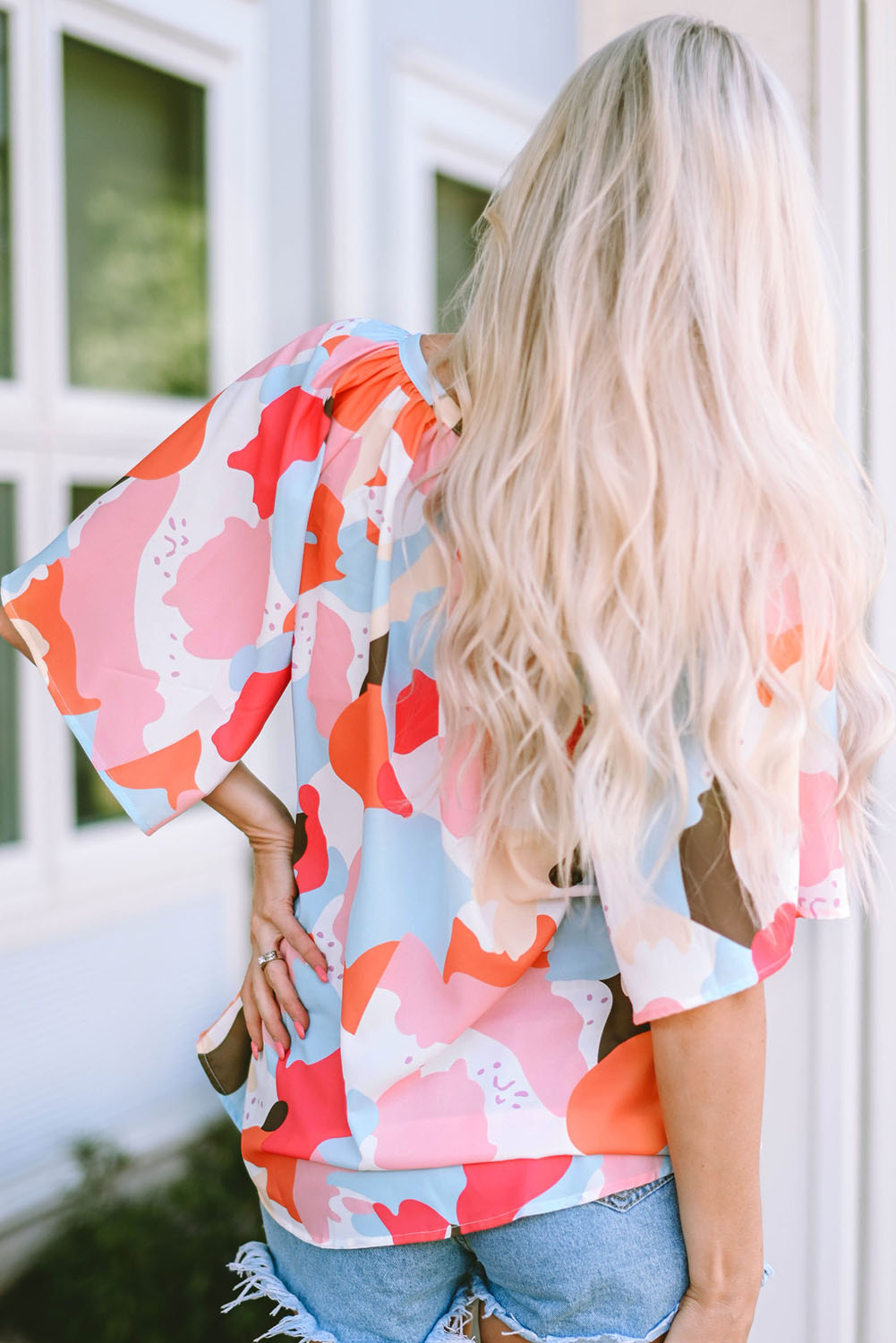 A stylish Floral Print V Neck Half Sleeve Blouse featuring a vibrant floral pattern, wide sleeves, and a flattering V-neckline, perfect for warm weather.