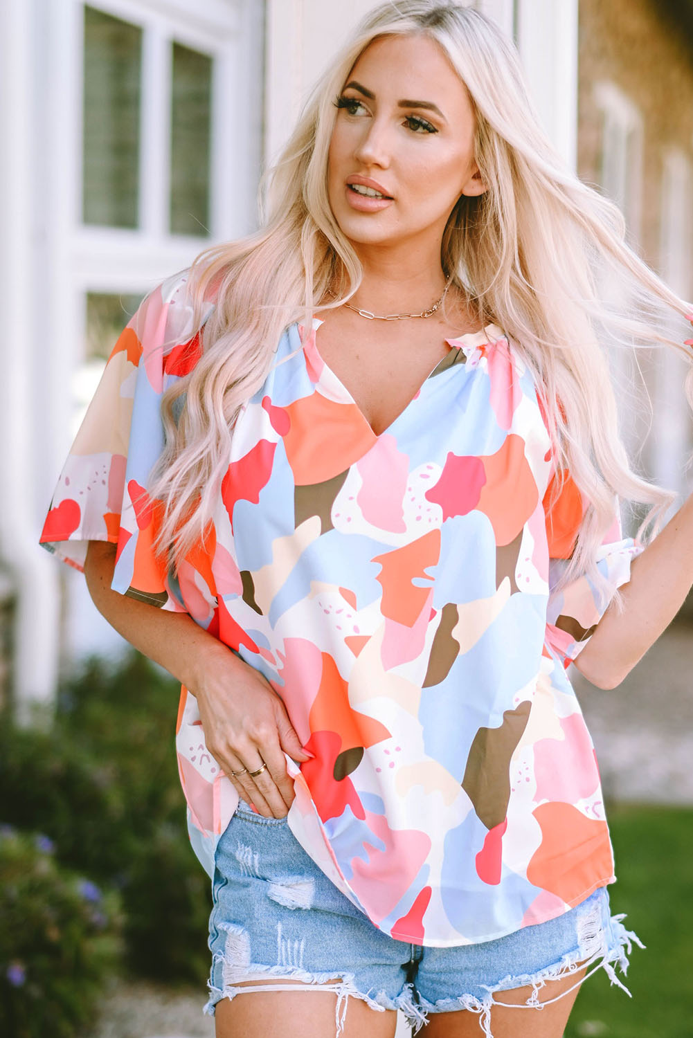 A stylish Floral Print V Neck Half Sleeve Blouse featuring a vibrant floral pattern, wide sleeves, and a flattering V-neckline, perfect for warm weather.