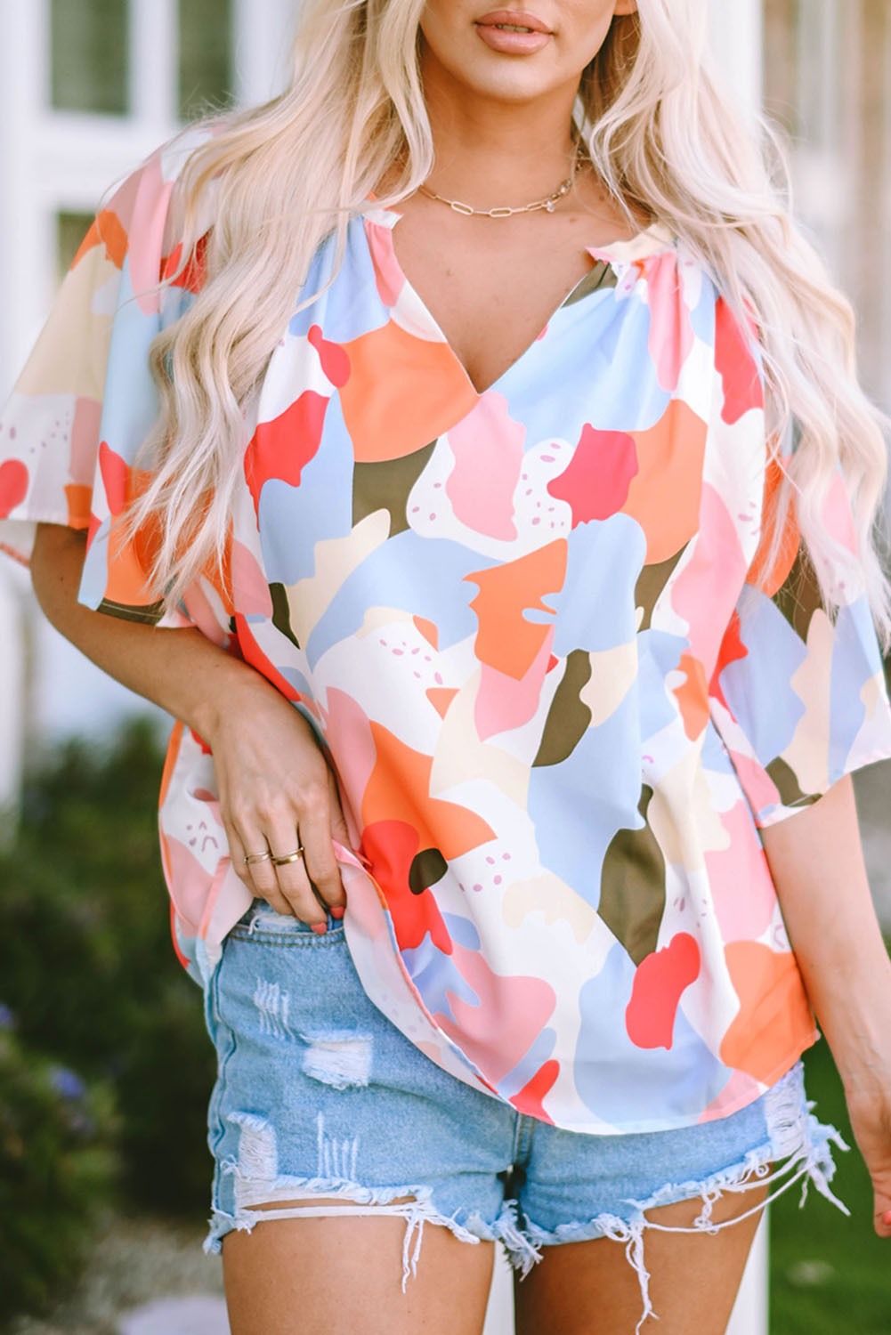 A stylish Floral Print V Neck Half Sleeve Blouse featuring a vibrant floral pattern, wide sleeves, and a flattering V-neckline, perfect for warm weather.