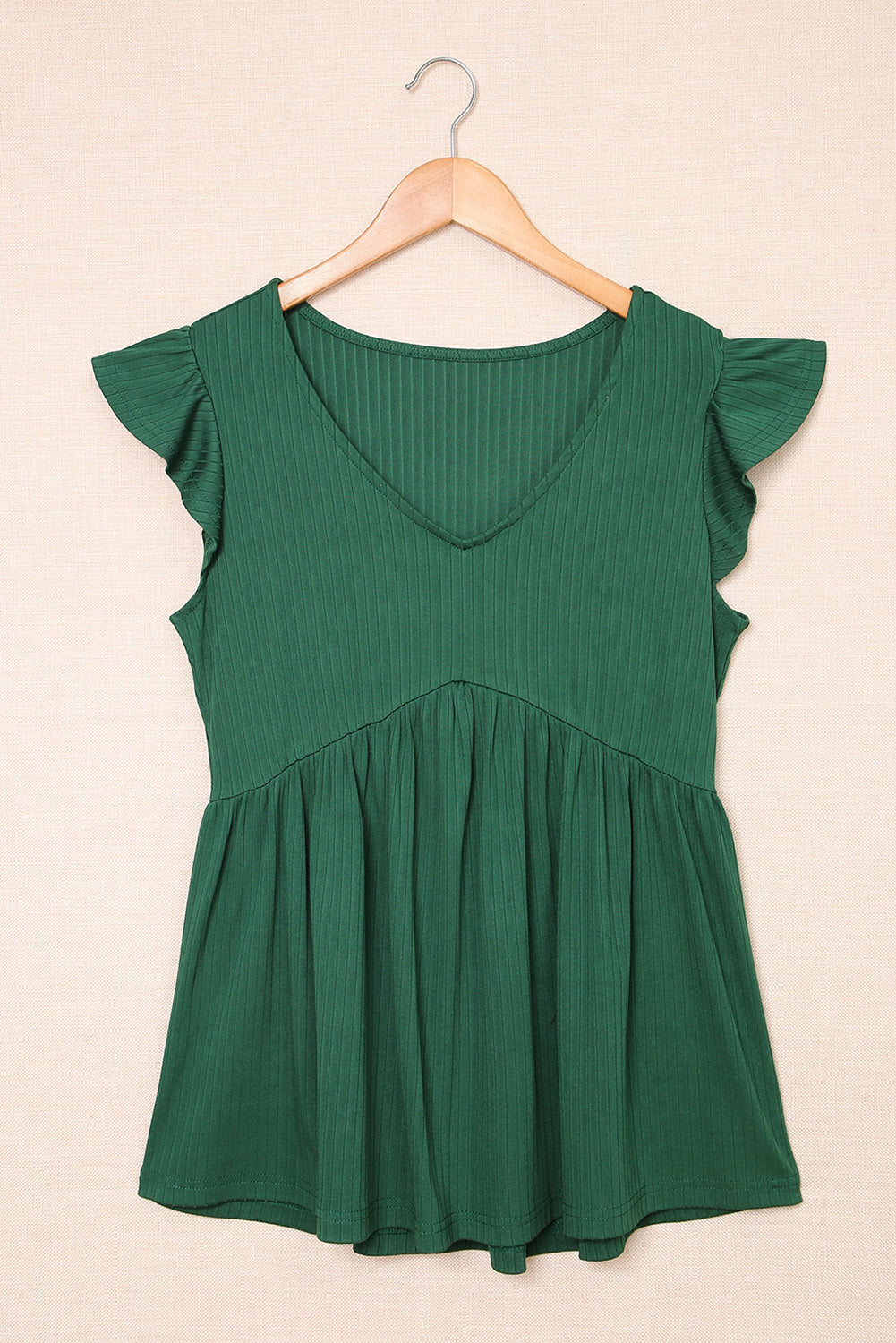 A stylish green V neck babydoll top featuring flutter sleeves and a flowy silhouette, perfect for casual outings.