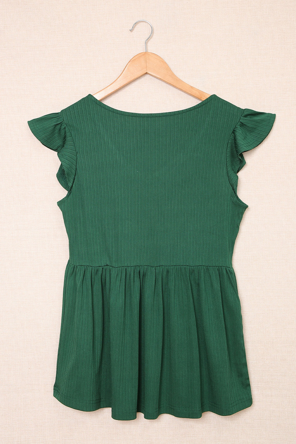 A stylish green V neck babydoll top featuring flutter sleeves and a flowy silhouette, perfect for casual outings.