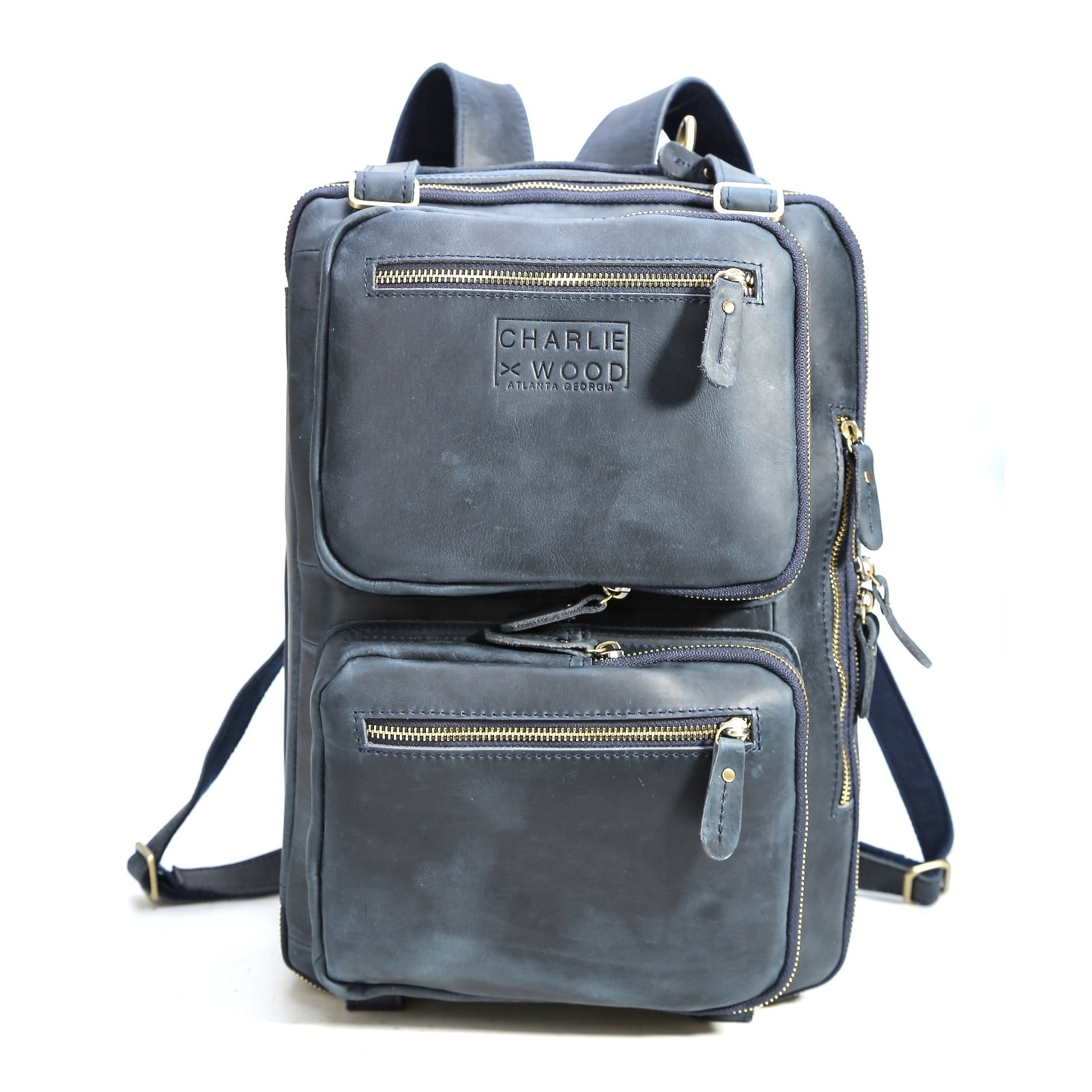 Hartwell leather bag in blue, showcasing its classic design and versatility as a backpack, briefcase, or messenger bag.