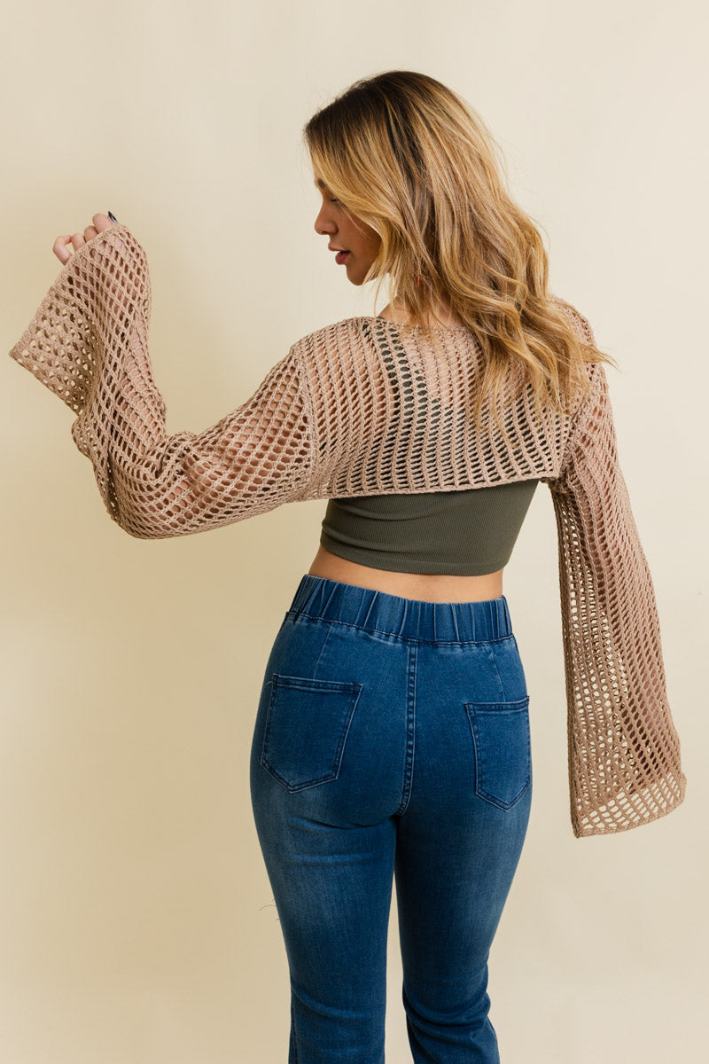 A cozy Loom Knitted Cropped Sweater in a stylish design, showcasing intricate knitted patterns and a modern cropped silhouette.