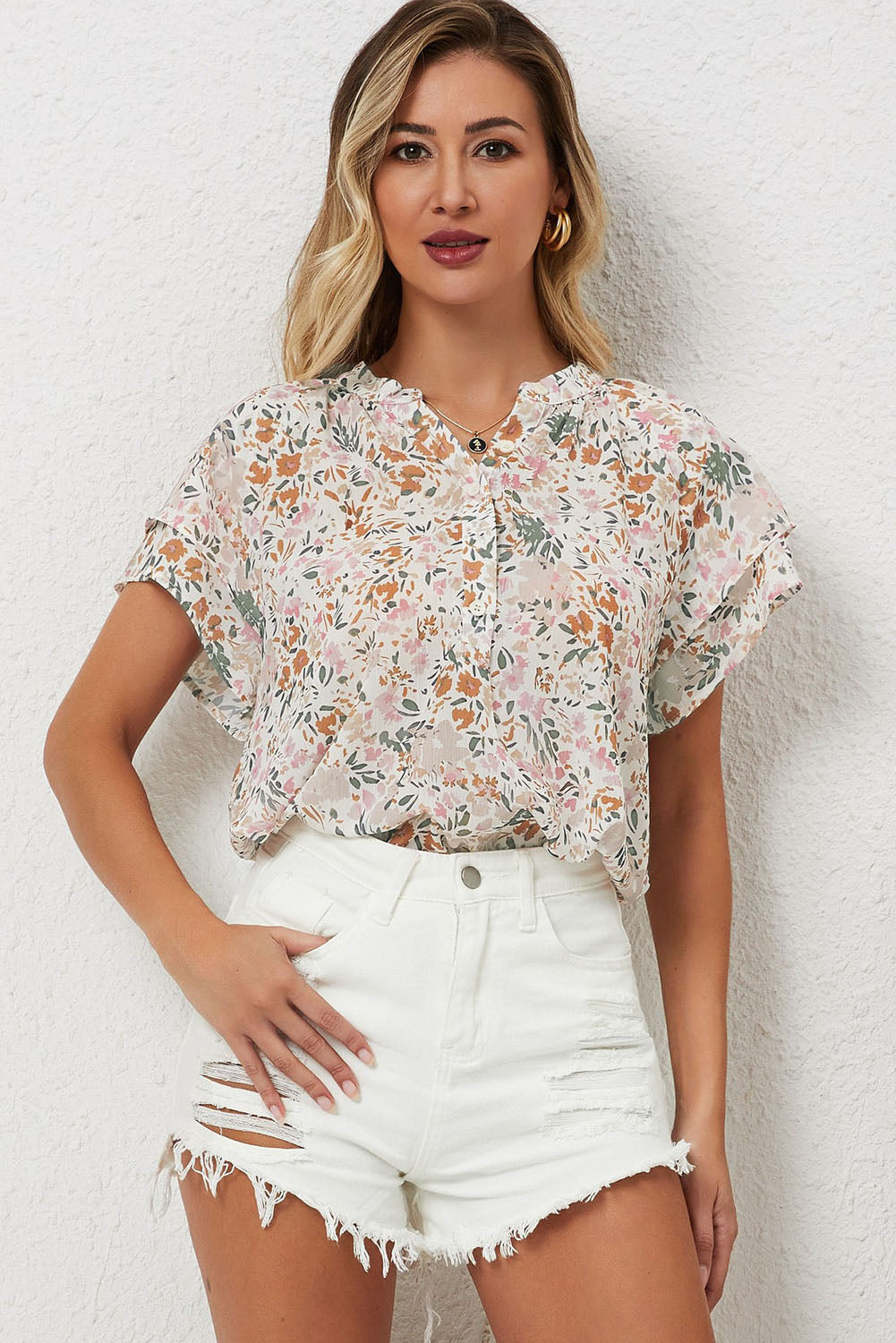 A vibrant multicolor floral mandarin collar top featuring short ruffle sleeves and a half button-front detail, perfect for spring fashion.