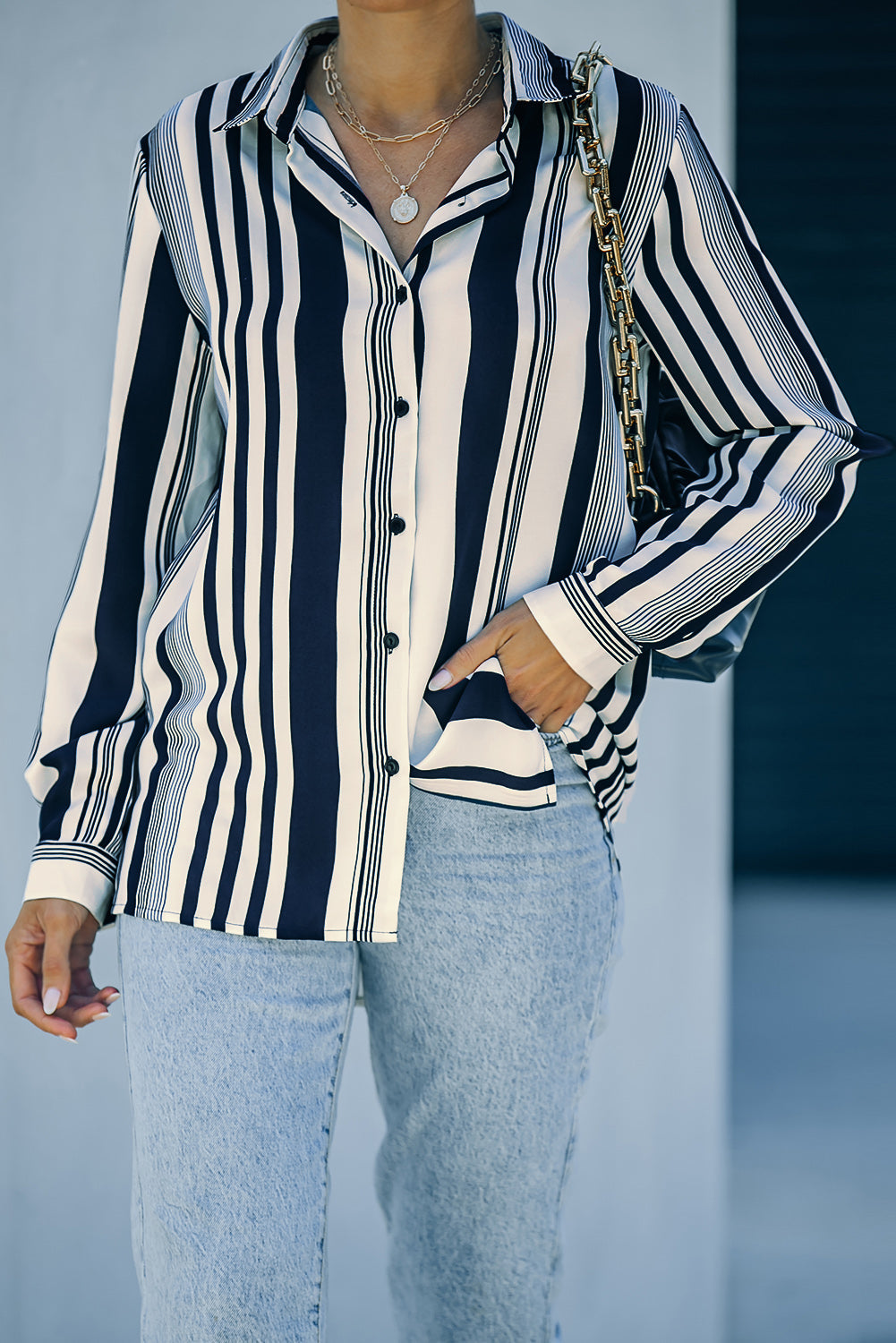 A stylish navy striped modern women's shirt featuring long sleeves and a tunic length, perfect for work or casual outings.