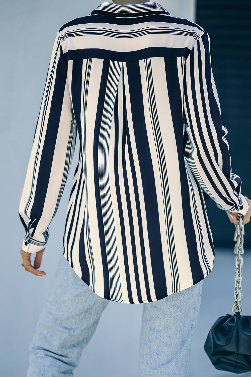 A stylish navy striped modern women's shirt featuring long sleeves and a tunic length, perfect for work or casual outings.