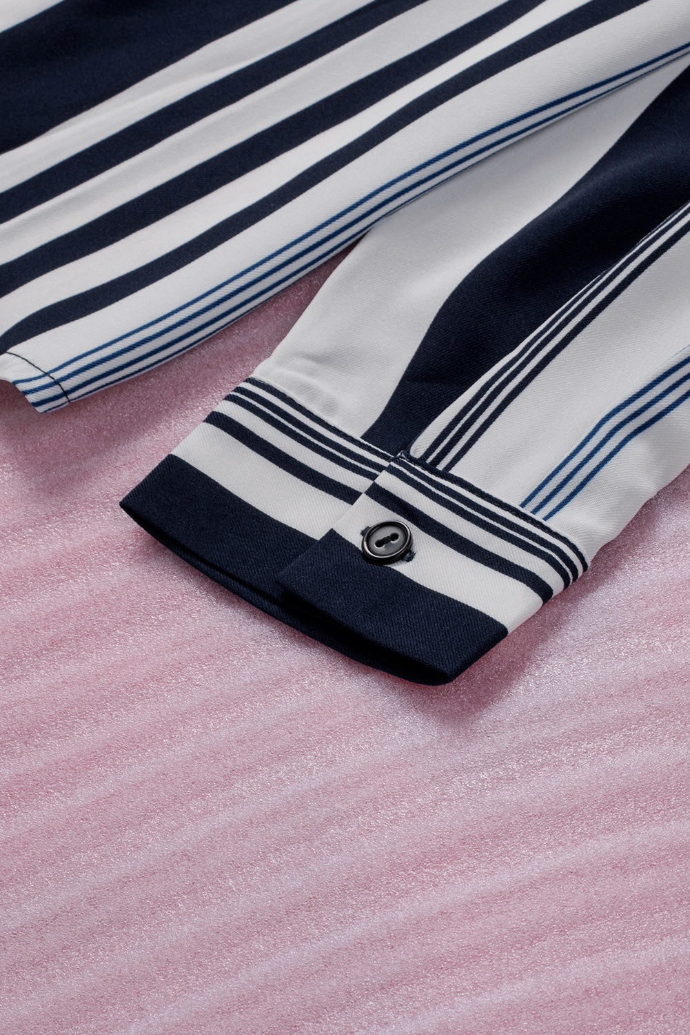 A stylish navy striped modern women's shirt featuring long sleeves and a tunic length, perfect for work or casual outings.