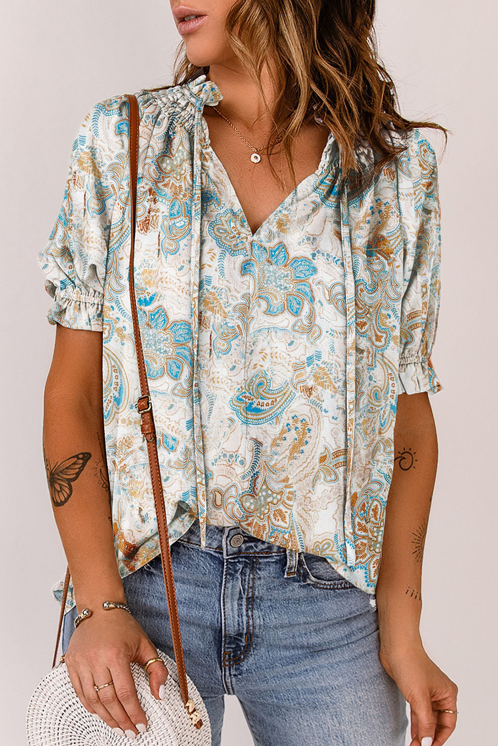 A stylish paisley pattern print V neck blouse with puff sleeves, showcasing a bohemian design perfect for casual and semi-formal occasions.