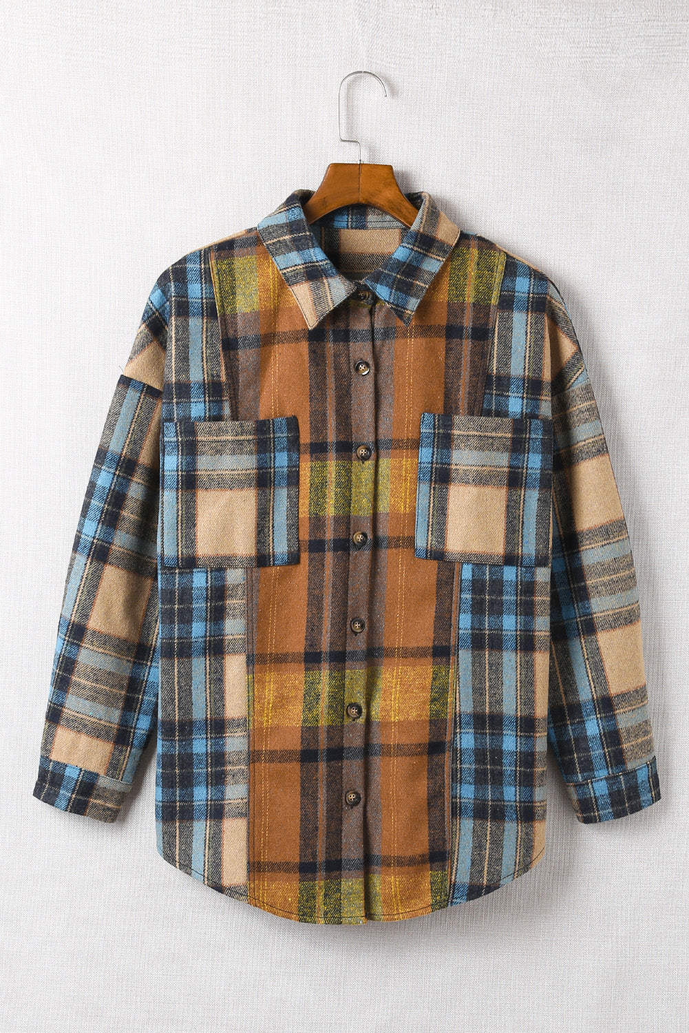 A stylish plaid color block buttoned shirt featuring functional pockets, perfect for fall fashion.