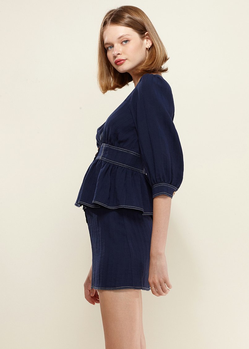 Puff Shoulder Button Front Peplum Top in Navy, featuring a deep v-neckline and half puff sleeves, styled with denim.