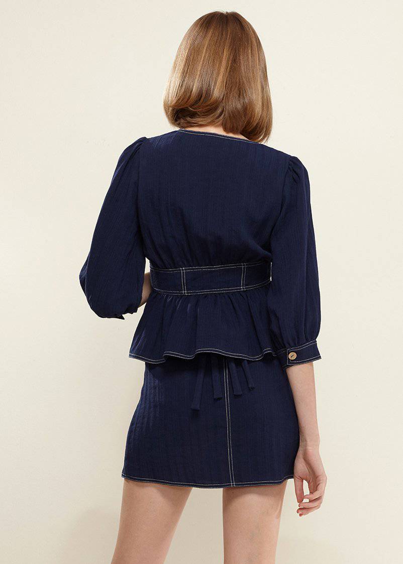 Puff Shoulder Button Front Peplum Top in Navy, featuring a deep v-neckline and half puff sleeves, styled with denim.