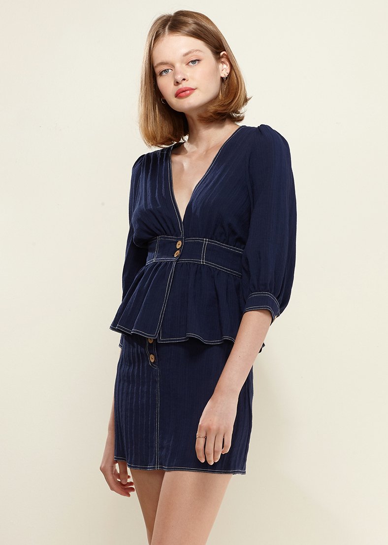 Puff Shoulder Button Front Peplum Top in Navy, featuring a deep v-neckline and half puff sleeves, styled with denim.