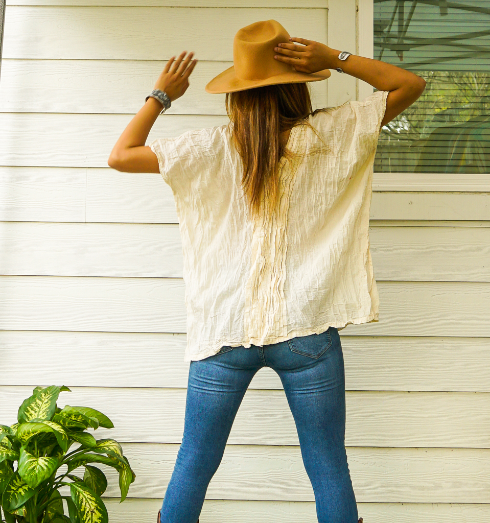 A stylish Raw Crinkled Cotton Gauze Blouse featuring 12 layers of sewn tucks, perfect for a bohemian look.