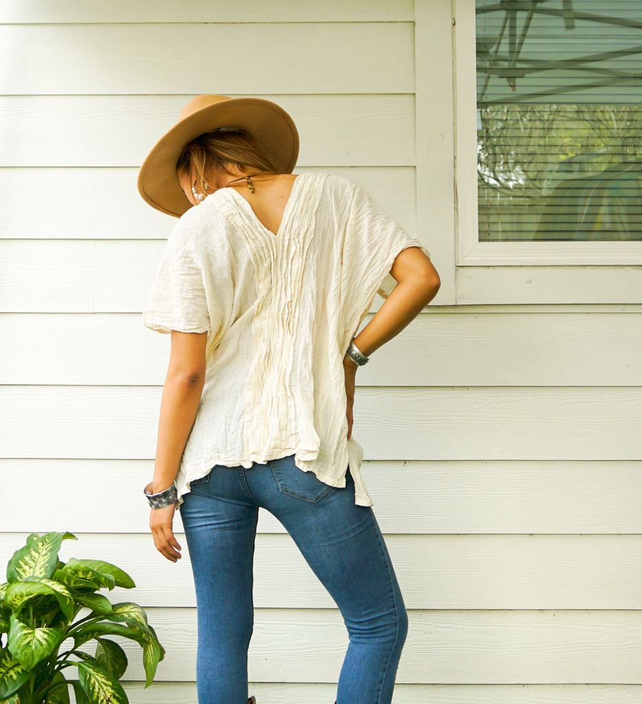 A stylish Raw Crinkled Cotton Gauze Blouse featuring 12 layers of sewn tucks, perfect for a bohemian look.