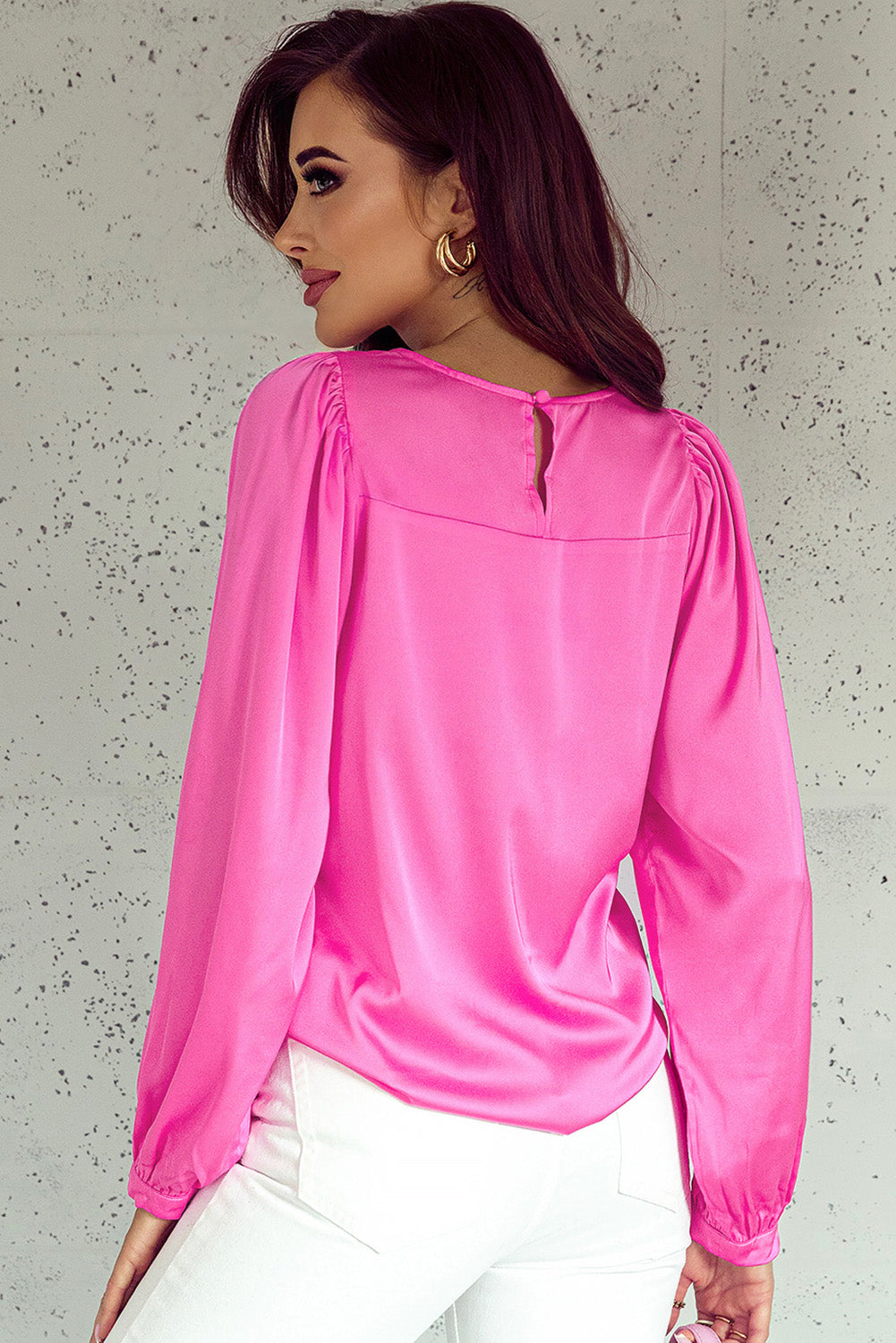 Elegant pink satin puff long sleeve crewneck blouse, showcasing a fitted design and sophisticated style.