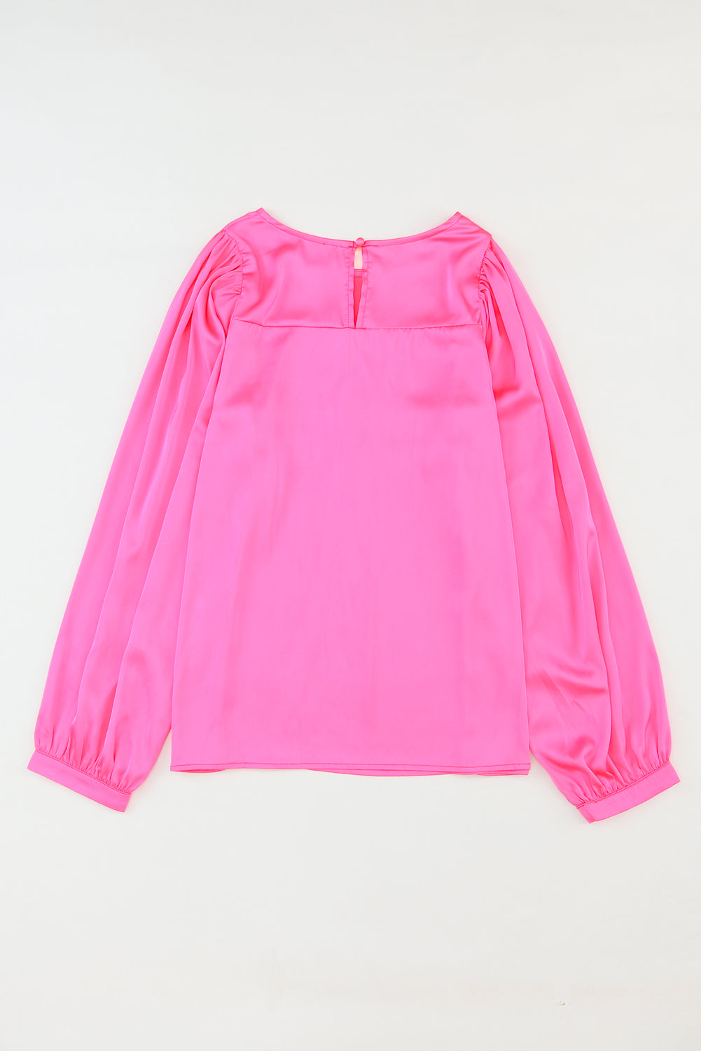 Elegant pink satin puff long sleeve crewneck blouse, showcasing a fitted design and sophisticated style.