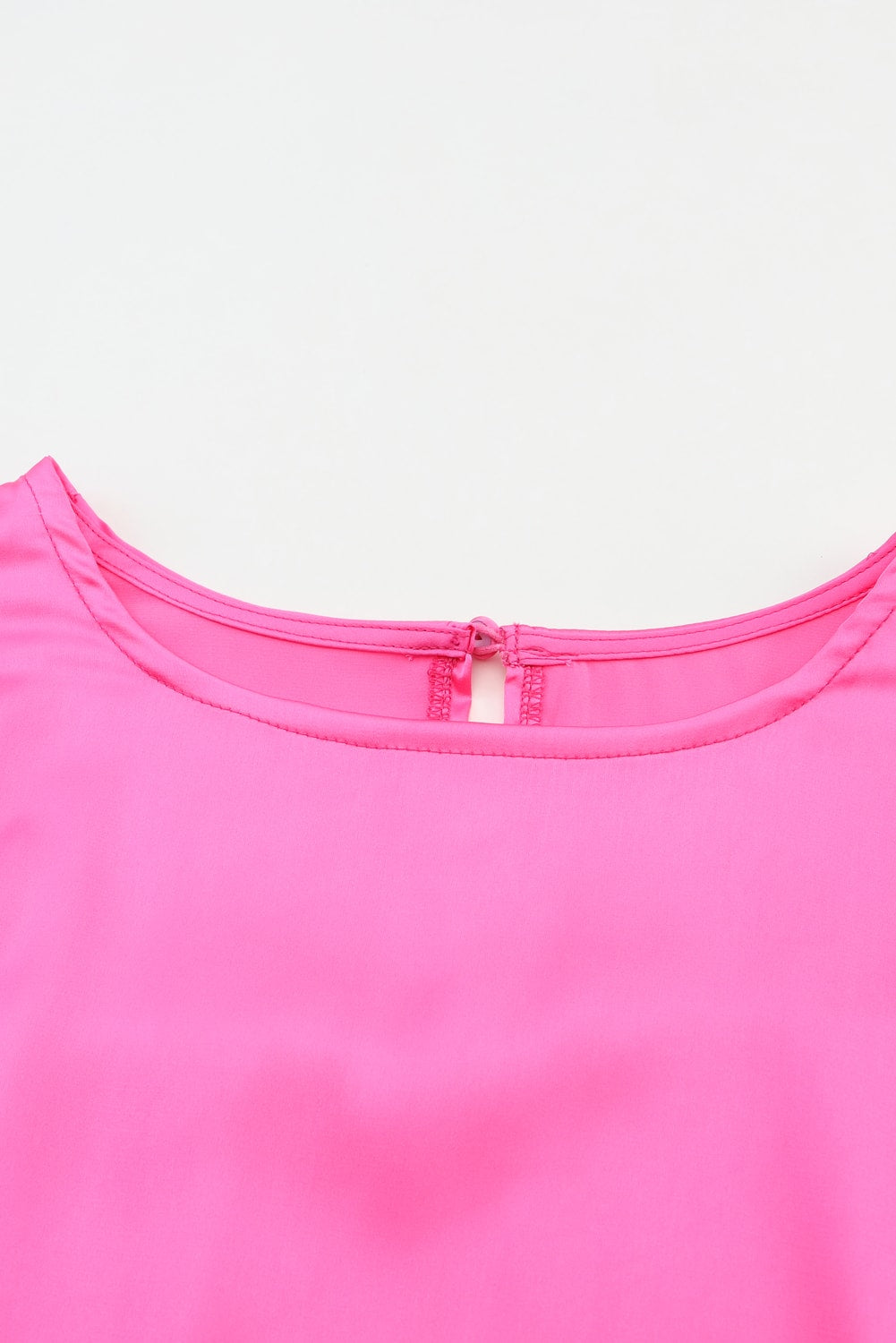 Elegant pink satin puff long sleeve crewneck blouse, showcasing a fitted design and sophisticated style.