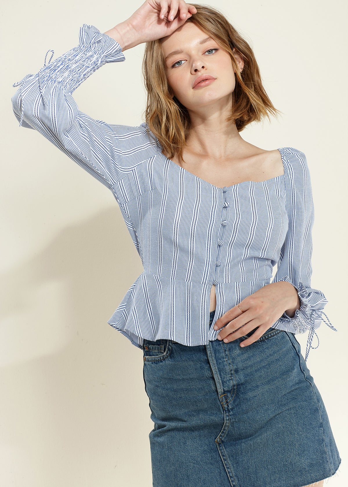 Nurode Smocked Cuff Button Front Peplum Blouse featuring button-up closure and smocked cuffs, perfect for stylish outfits.