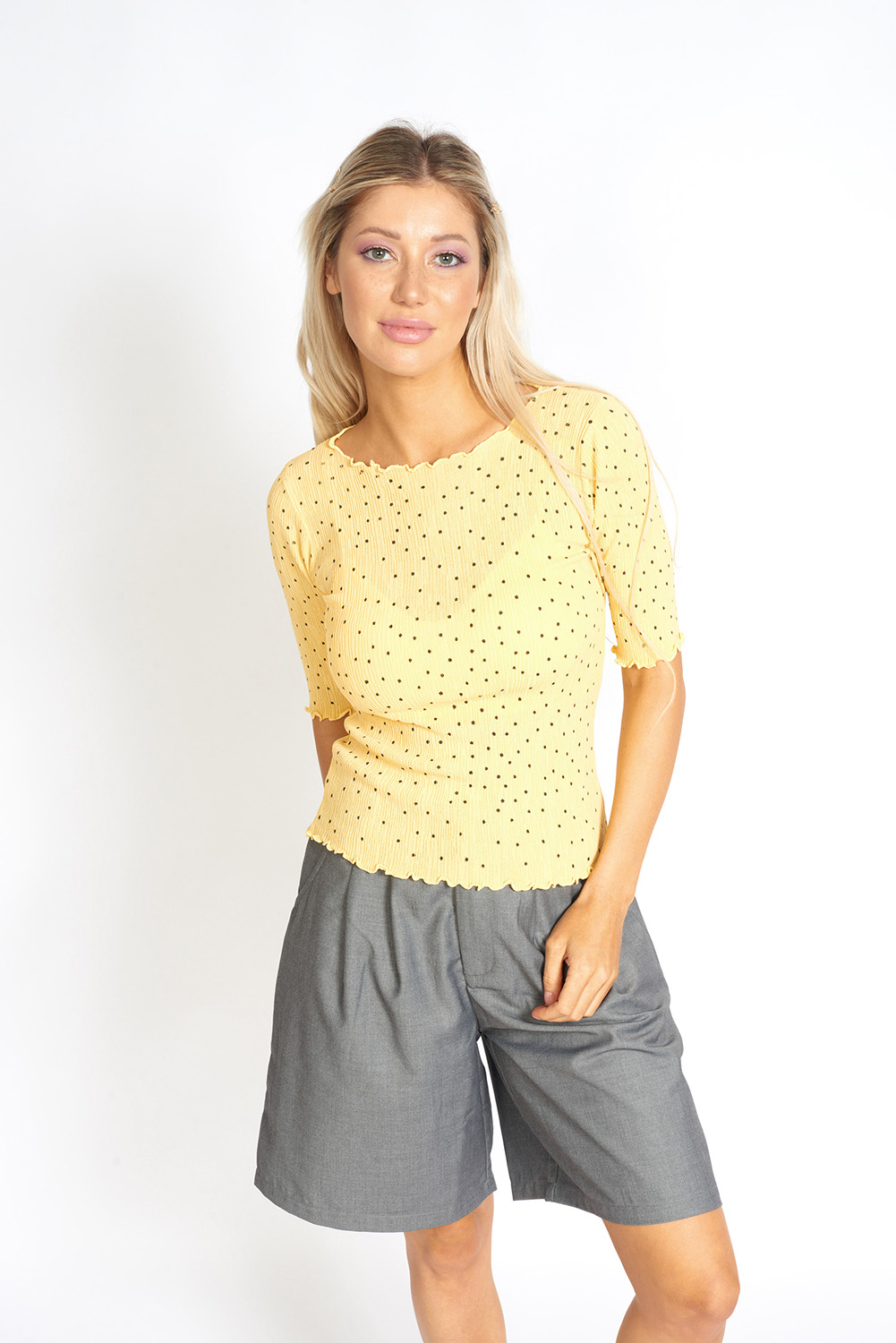 So Sweet Frill Polka Dots Top featuring a modest round neck, ruffled edges, and baseball style sleeves in a lightweight fabric.