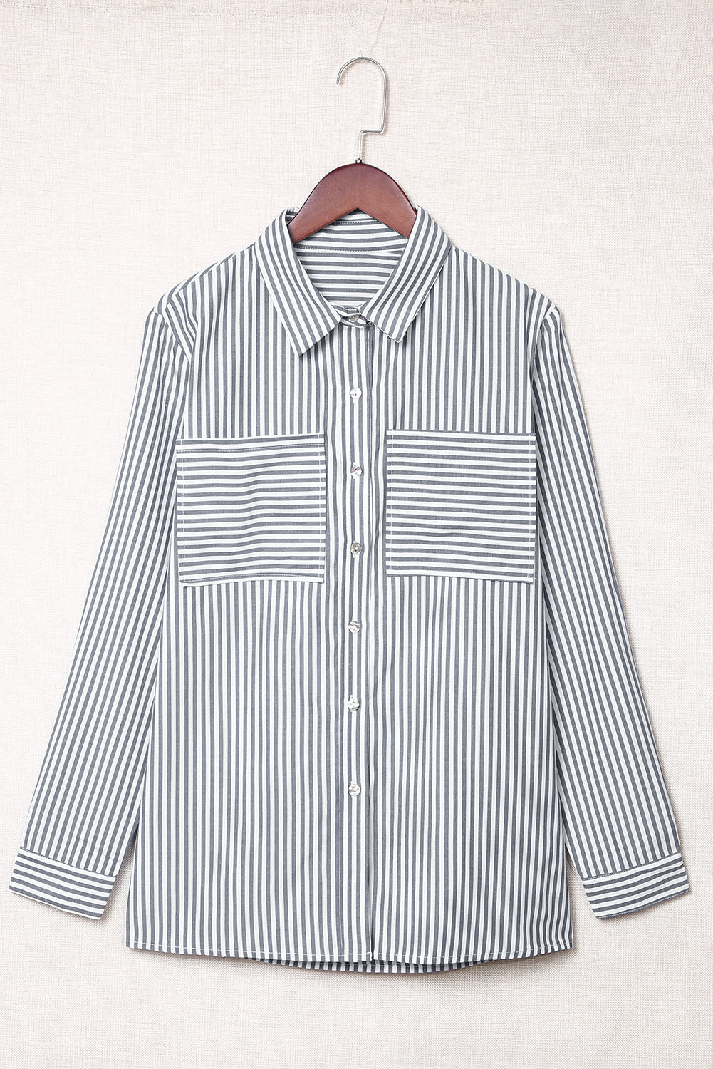 A stylish women's long sleeve shirt featuring a striped pattern, button-down front, and practical pockets, perfect for casual and formal occasions.