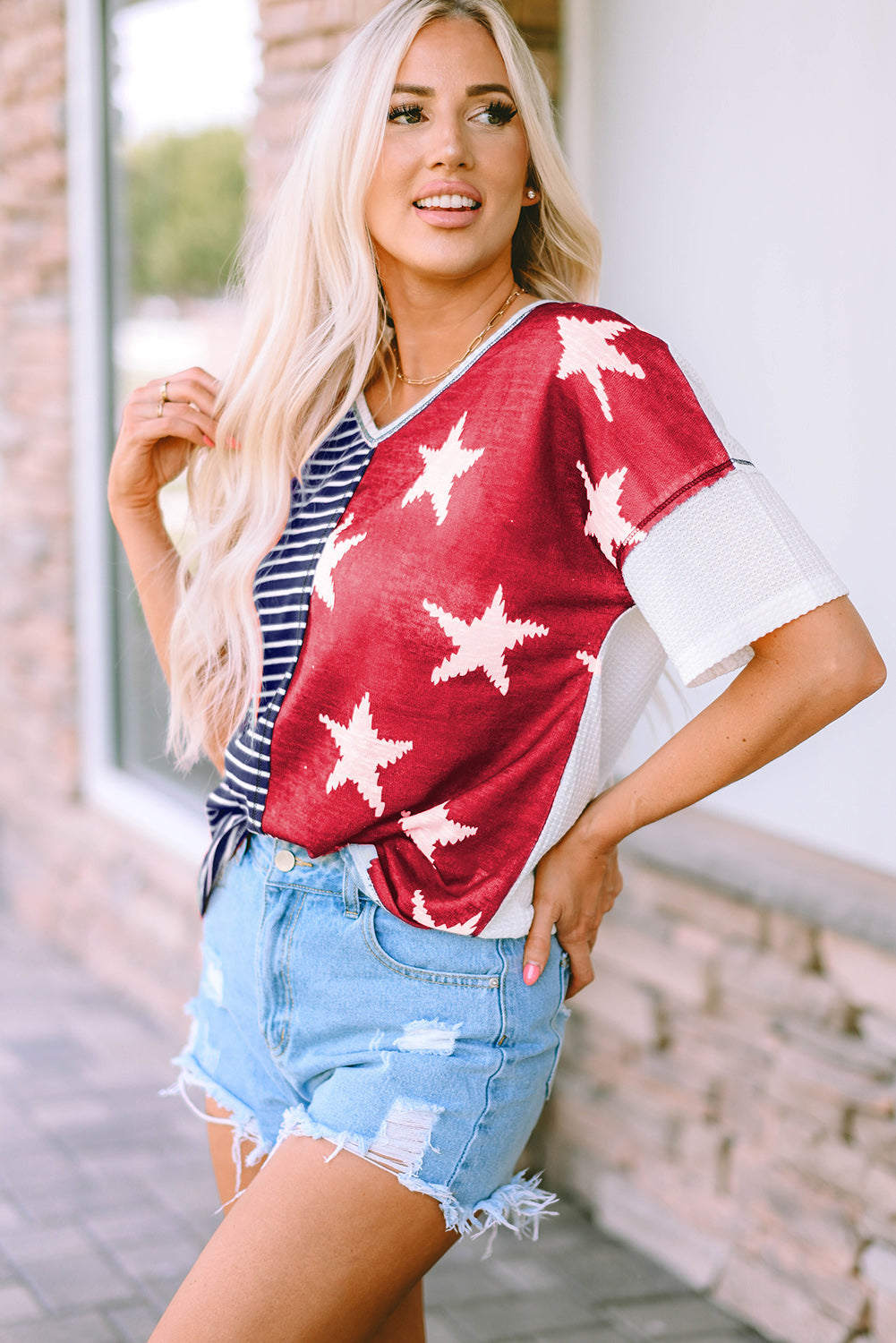 A stylish Stripes Stars Print Knit Top featuring bold stripes and star patterns, perfect for casual wear.