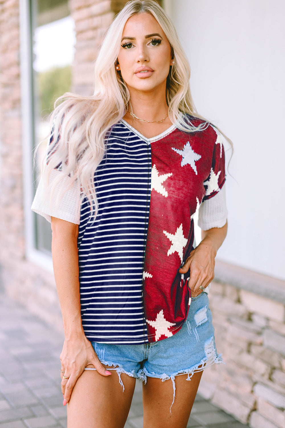 A stylish Stripes Stars Print Knit Top featuring bold stripes and star patterns, perfect for casual wear.