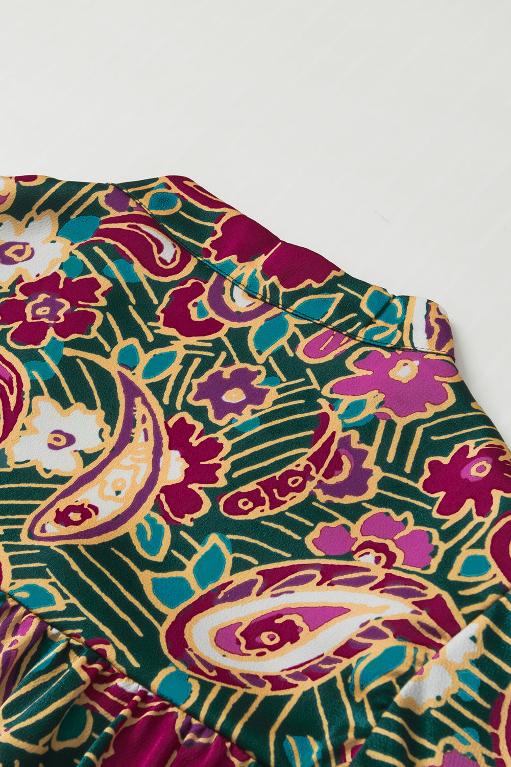 A stylish V Neck Short Bubble Sleeve Paisley Blouse featuring a vibrant paisley print, short bubble sleeves, and a loose fit, perfect for casual or formal wear.