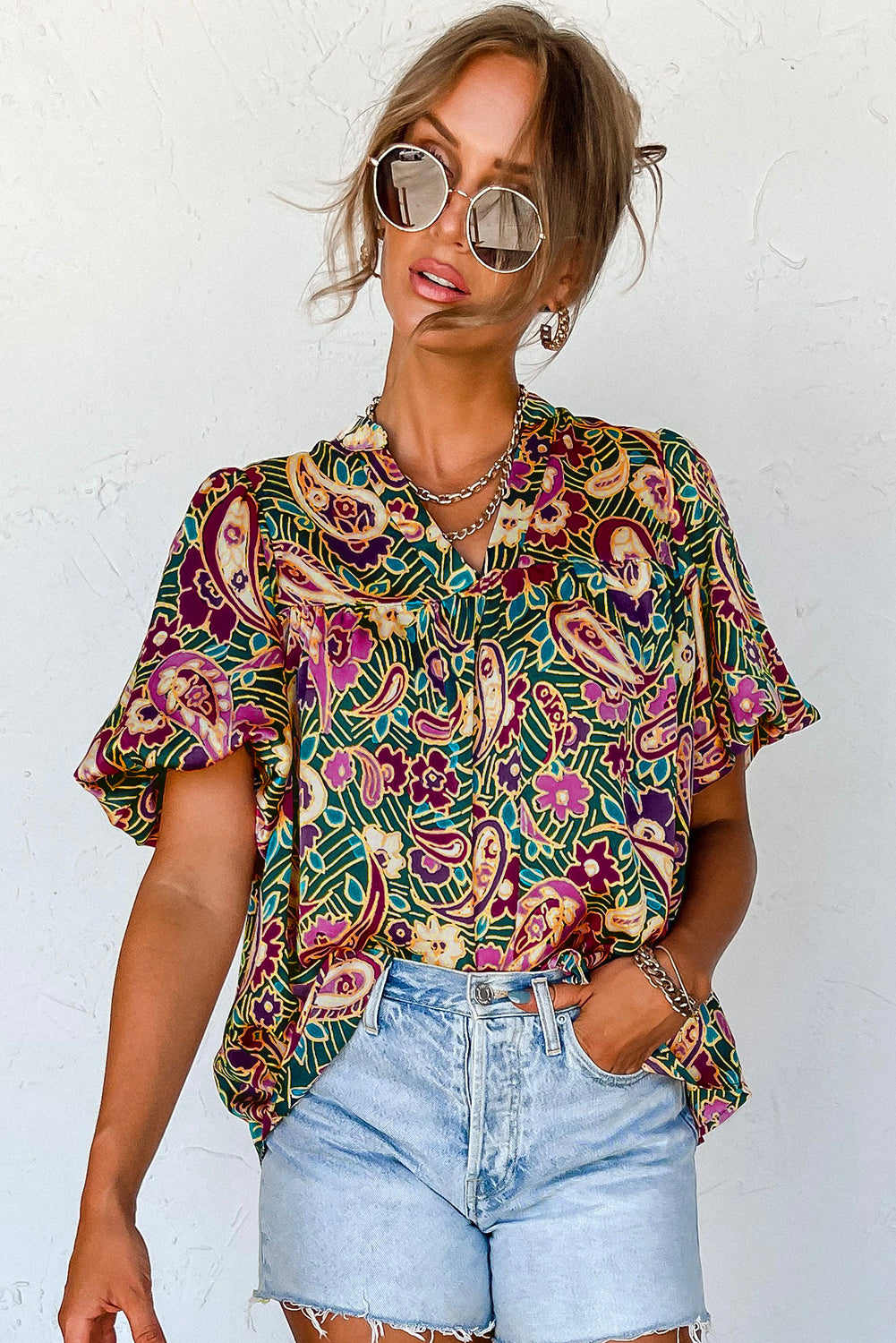 A stylish V Neck Short Bubble Sleeve Paisley Blouse featuring a vibrant paisley print, short bubble sleeves, and a loose fit, perfect for casual or formal wear.